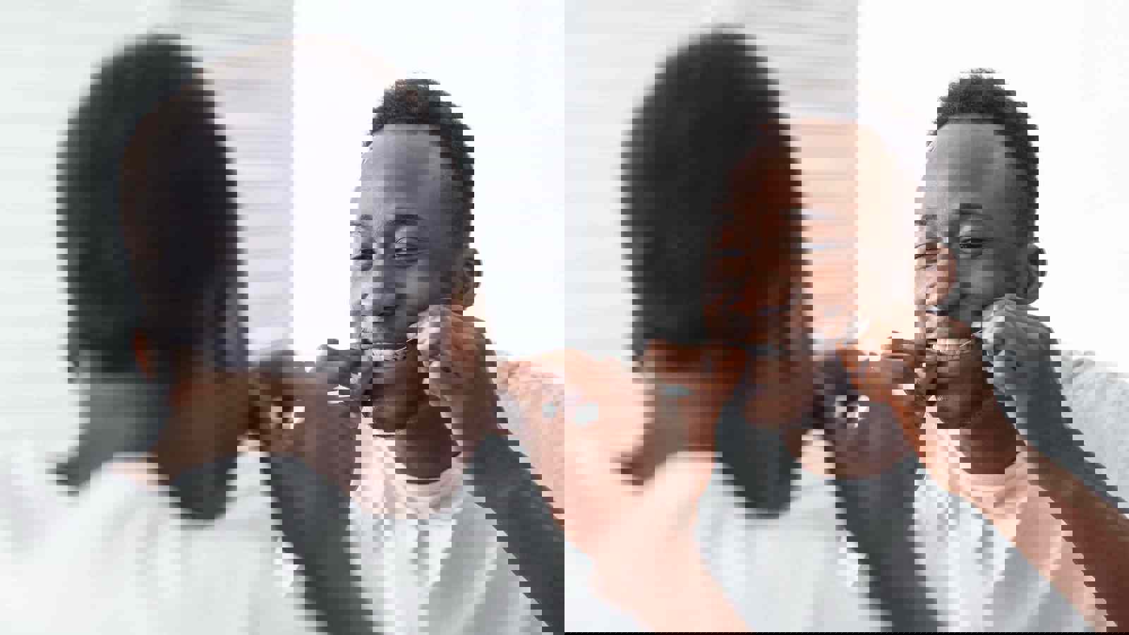 Person flossing in mirror