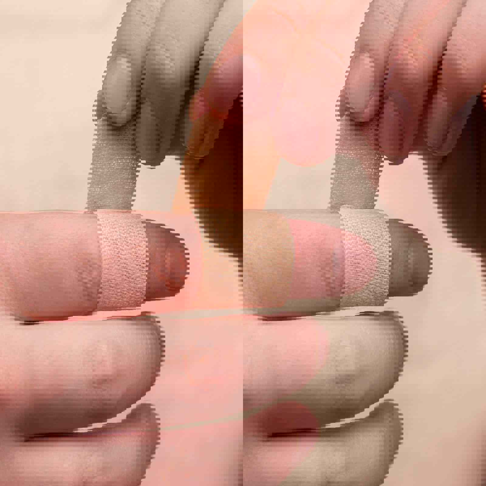 Person applying a plaster to their finger